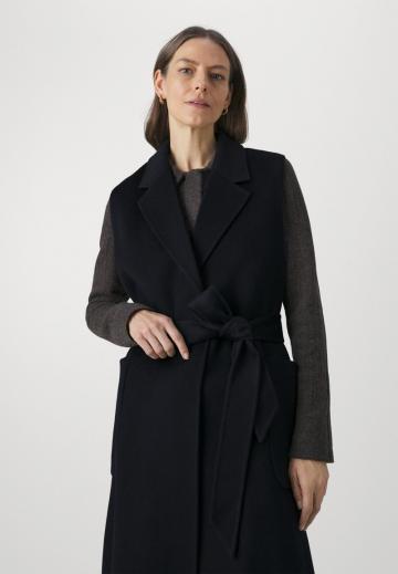 Длинный жилет