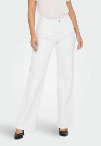 Клешеные джинсы