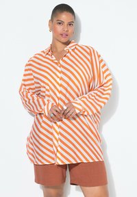 Длинная блузка