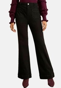 Клешеные джинсы