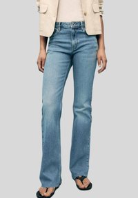 Клешеные джинсы