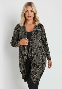 Длинный жилет