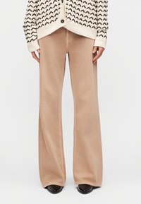 Клешеные джинсы Клешеные джинсы